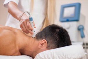 Therapeutic laser technology - therapist pointing medical laser beam to a spot on a patient's neck